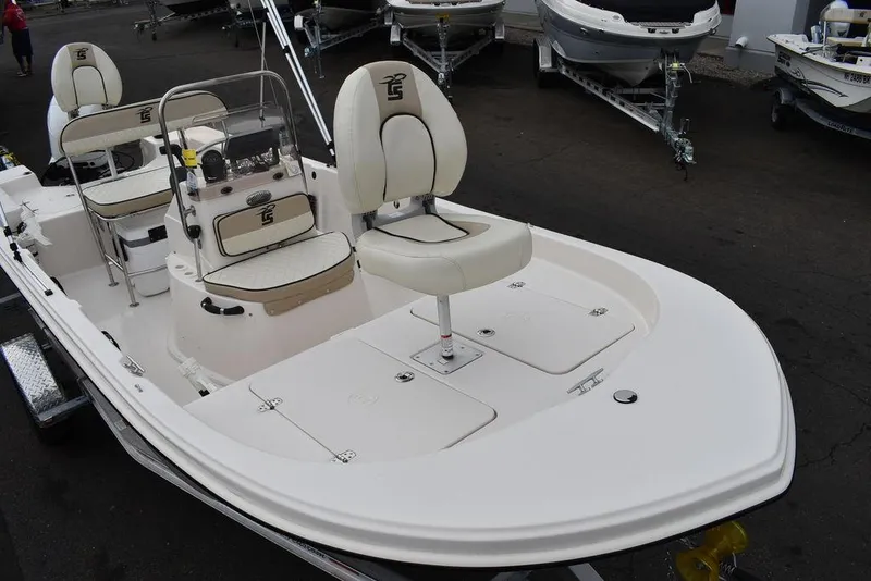Slide: The Image of 2023 Carolina Skiff 178 JLS boat with white seating and storage compartments. - 14