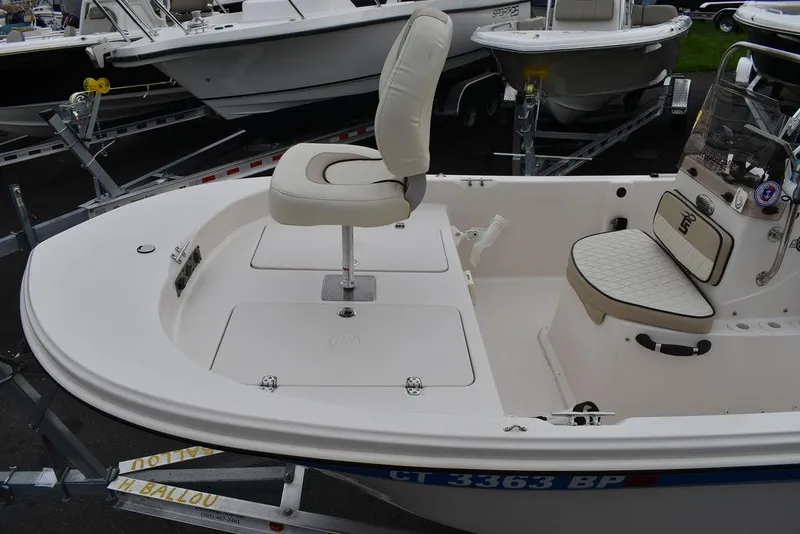 Slide: The Image of 2023 Carolina Skiff 178 JLS boat interior with seating and storage compartments. - 17