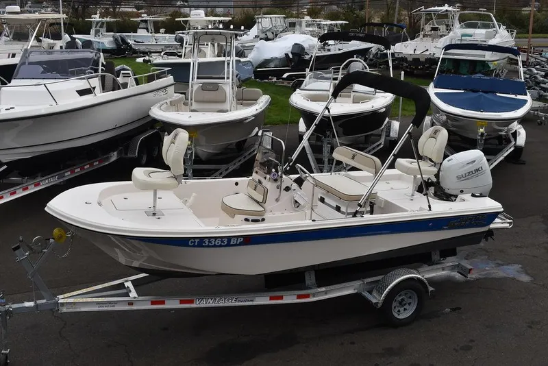 Slide: The Image of 2023 Carolina Skiff 178 JLS boat on a trailer, surrounded by other boats. - 2