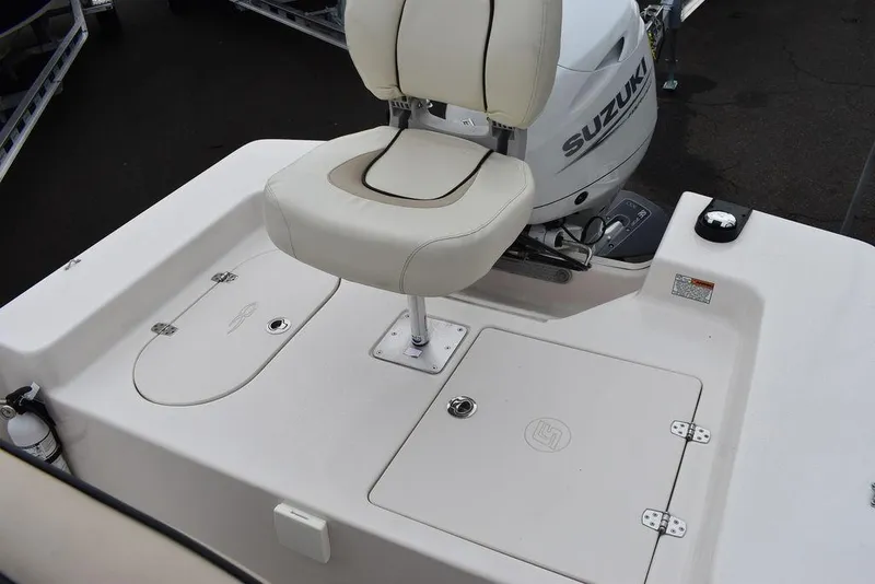 Slide: The Image of 2023 Carolina Skiff 178 JLS boat with Suzuki outboard motor and cushioned seat. - 20