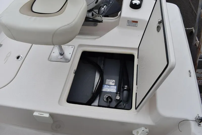Slide: The Image of 2023 Carolina Skiff 178 JLS boat with open storage compartment and seat. - 21