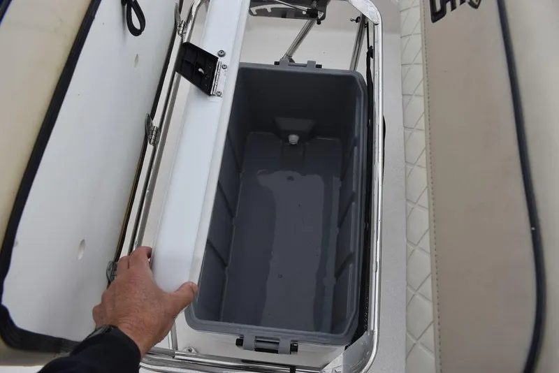 Slide: The Image of 2023 Carolina Skiff 178 JLS storage compartment with open lid. - 26
