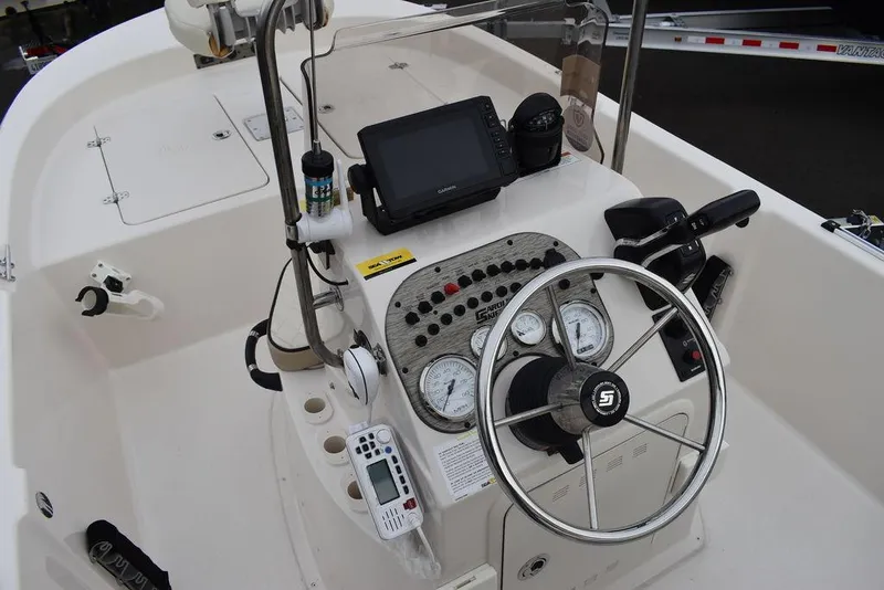 Slide: The Image of 2023 Carolina Skiff 178 JLS boat console with steering wheel, gauges, and navigation equipment. - 30