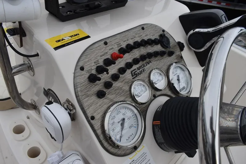 Slide: The Image of 2023 Carolina Skiff 178 JLS boat dashboard with gauges and controls. - 33