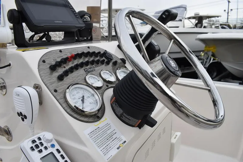 Slide: The Image of 2023 Carolina Skiff 178 JLS boat console with steering wheel and control panel. - 34