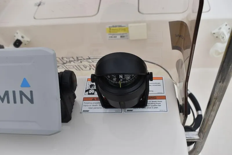 Slide: The Image of 2023 Carolina Skiff 178 JLS boat console with compass and Garmin device. - 35