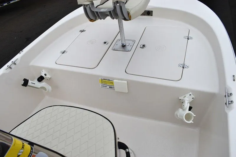 Slide: The Image of 2023 Carolina Skiff 178 JLS boat interior with storage compartments and rod holders. - 38