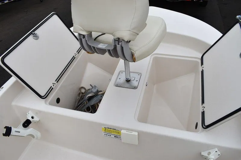 Slide: The Image of 2023 Carolina Skiff 178 JLS boat with open storage compartments and seating. - 39