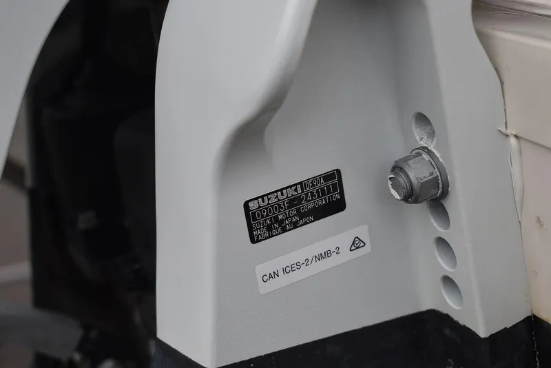 Slide: The Image of Close-up of a 2023 Carolina Skiff 178 JLS boat engine part with Suzuki label. - 43