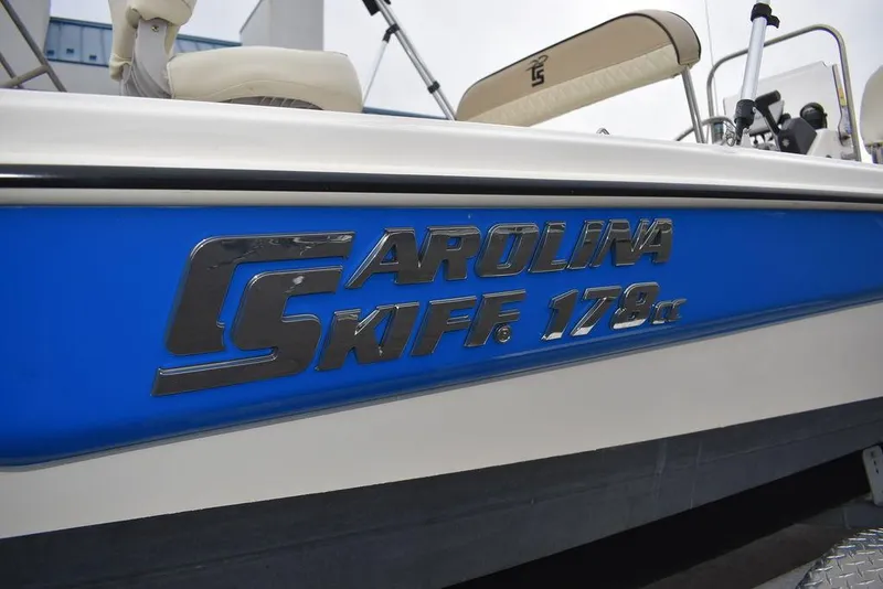 Slide: The Image of 2023 Carolina Skiff 178 JLS boat side view with logo. - 45