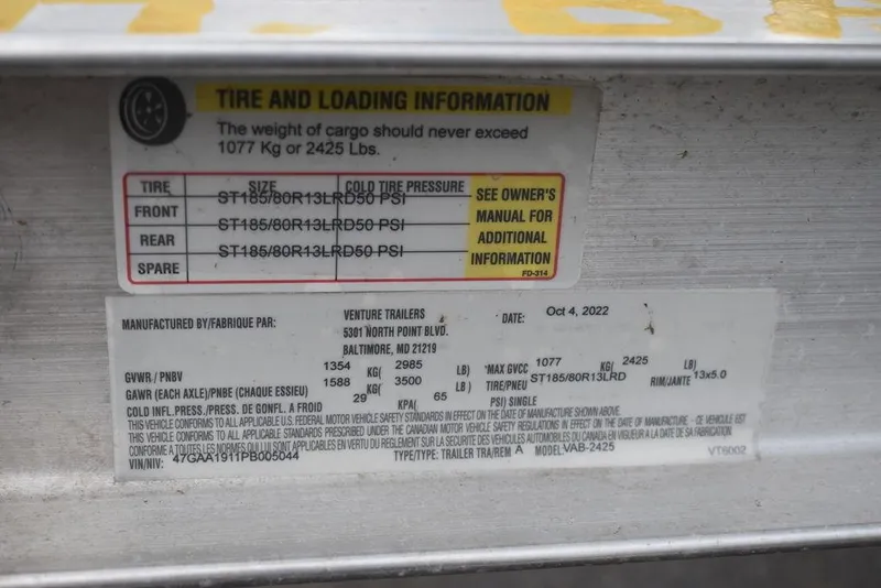 Slide: The Image of Tire and loading information label on a 2023 Carolina Skiff 178 JLS. - 47