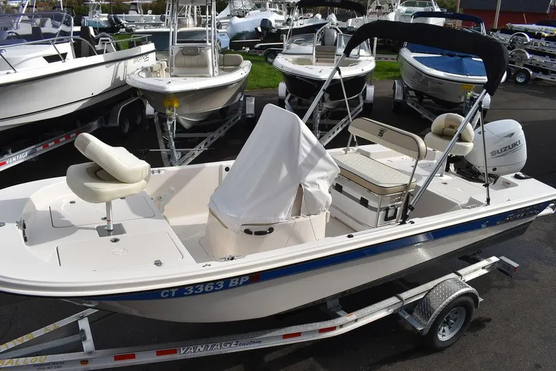 Slide: The Image of 2023 Carolina Skiff 178 JLS boat on trailer, surrounded by other boats. - 5