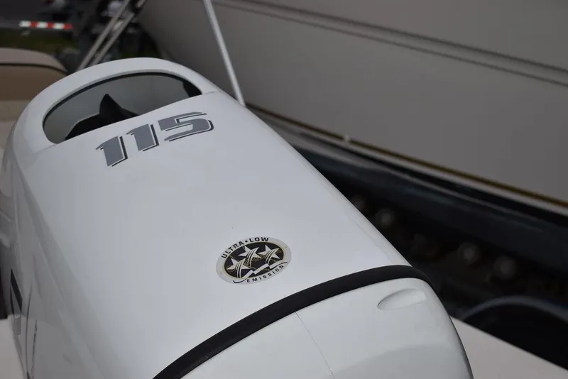 Slide: The Image of Outboard motor on 2023 Carolina Skiff 192 JLS boat, featuring 115 horsepower. - 13