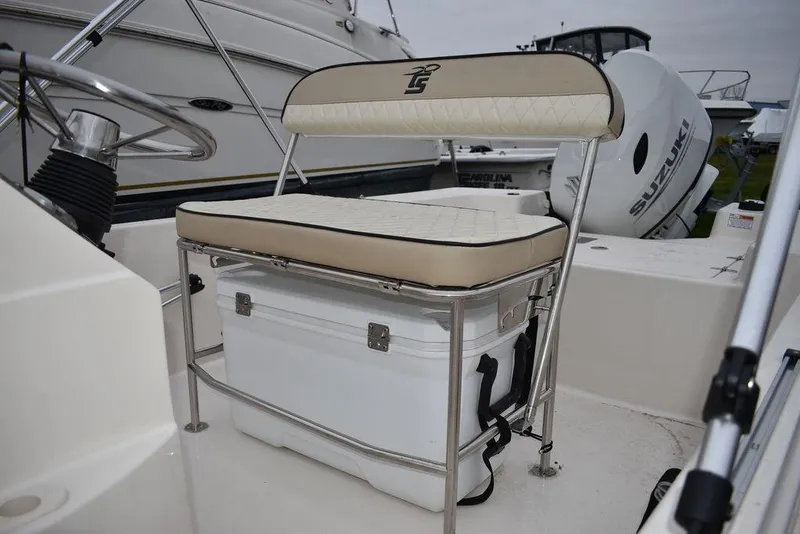 Slide: The Image of 2023 Carolina Skiff 192 JLS boat interior with cushioned seat and storage cooler. - 6
