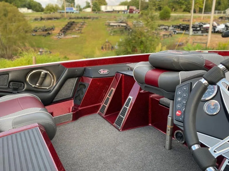 Slide: The Image of 2020 Ranger Z520C boat interior with red and gray seating, steering wheel, and control panel. - 11