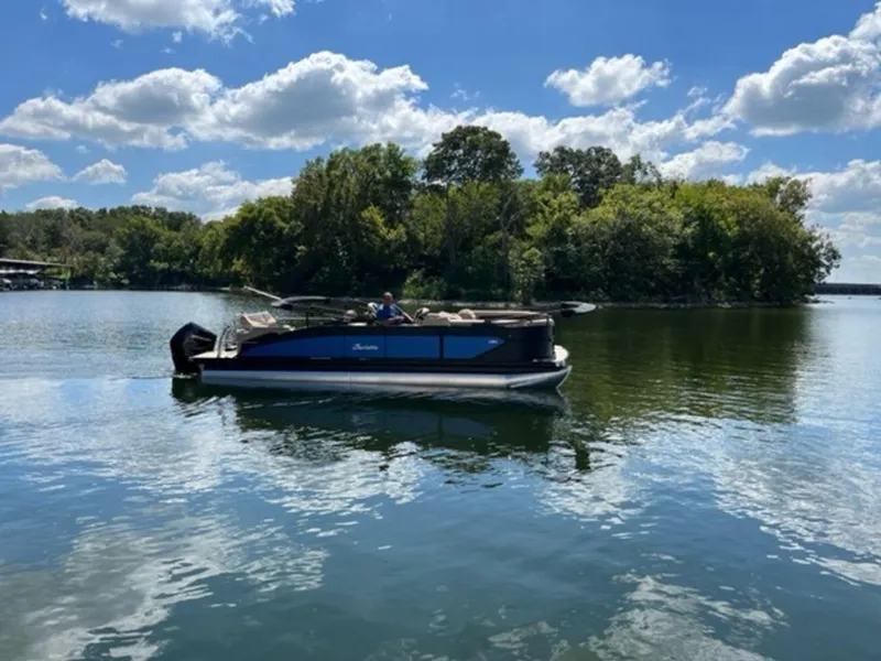 Slide: The Image of 2023 Barletta Cabrio 24 UE pontoon boat on a serene lake. - 1