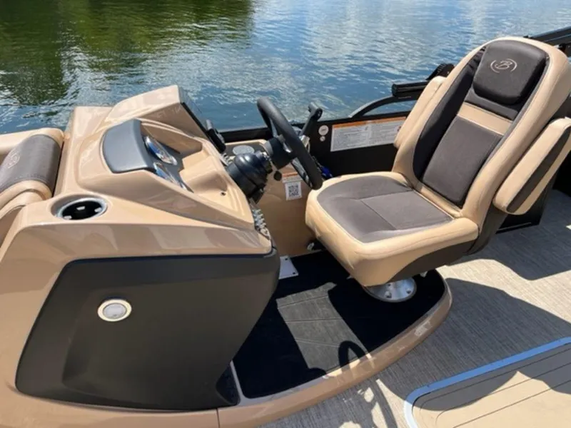 Slide: The Image of 2023 Barletta Cabrio 24 UE boat helm with captain's chair and water background. - 10