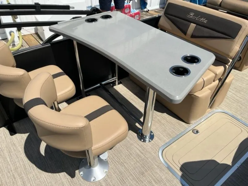 Slide: The Image of 2023 Barletta Cabrio 24 UE interior with beige seating and table with cup holders. - 12