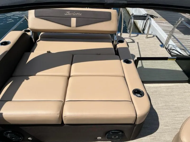 Slide: The Image of 2023 Barletta Cabrio 24 UE boat with tan leather seating and cup holders. - 14