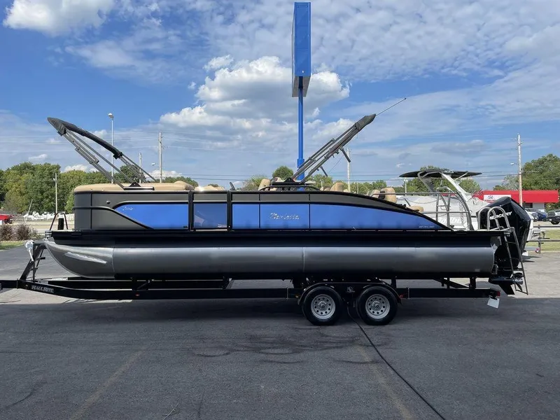 Slide: The Image of 2023 Barletta Cabrio 24 UE pontoon boat on a trailer under a blue sky. - 15