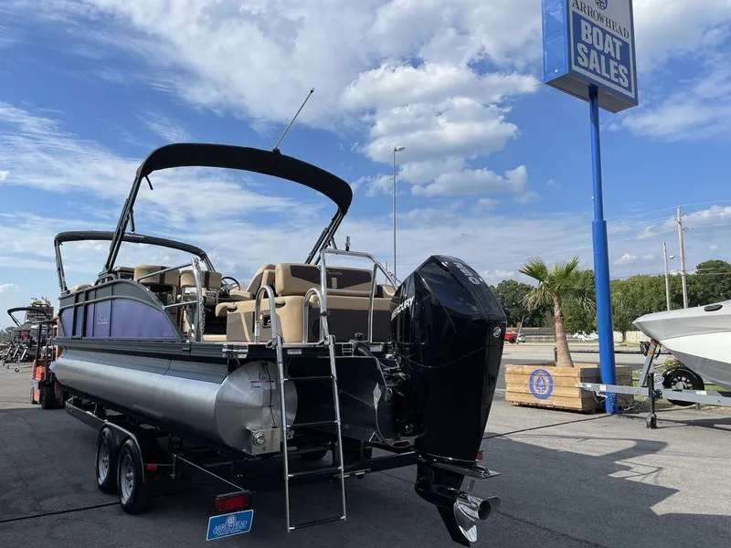 Slide: The Image of 2023 Barletta Cabrio 24 UE pontoon boat at a dealership under a blue sky. - 17