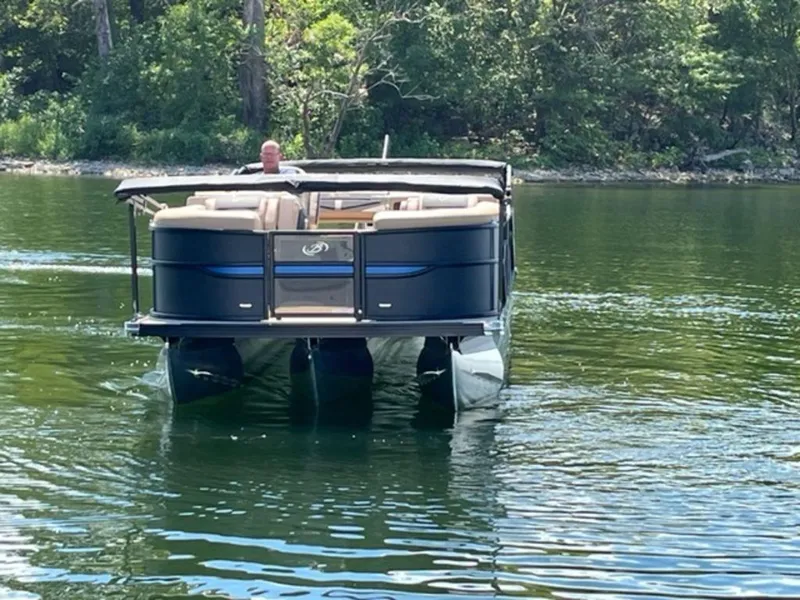 Slide: The Image of 2023 Barletta Cabrio 24 UE pontoon boat cruising on a lake. - 19