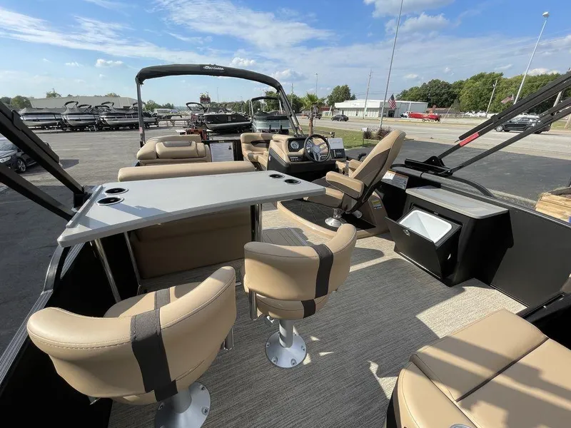 Slide: The Image of 2023 Barletta Cabrio 24 UE pontoon boat with beige seating and table. - 22