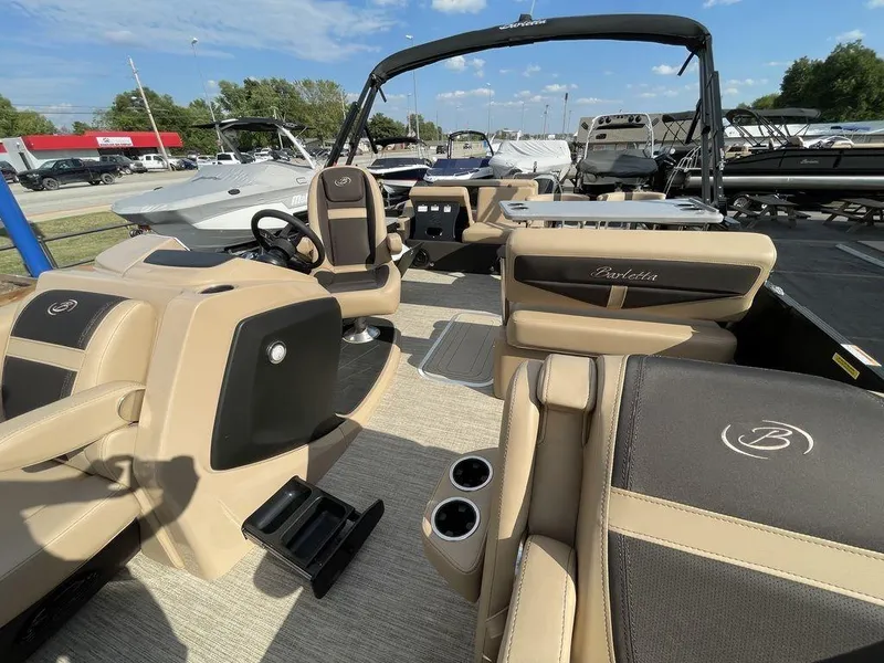Slide: The Image of 2023 Barletta Cabrio 24 UE pontoon boat with luxurious tan and black interior. - 25