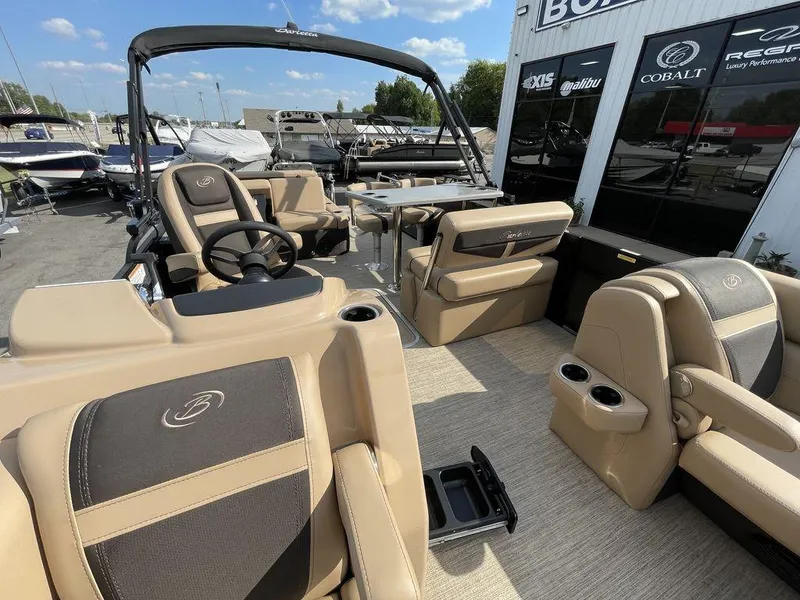 Slide: The Image of 2023 Barletta Cabrio 24 UE pontoon boat interior with tan and black seating. - 28