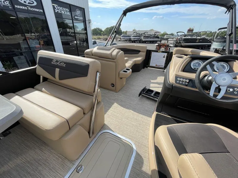 Slide: The Image of 2023 Barletta Cabrio 24 UE pontoon boat interior with beige seating and modern dashboard. - 34