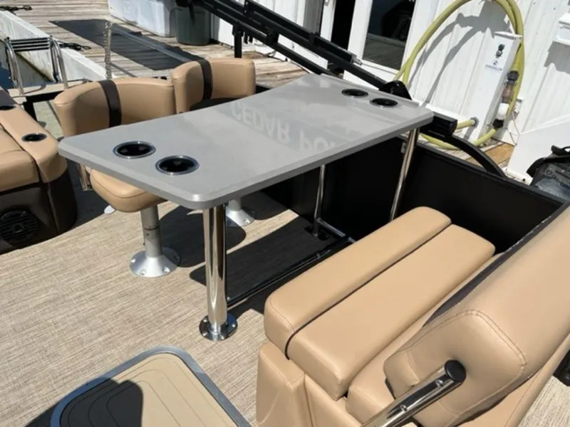 Slide: The Image of 2023 Barletta Cabrio 24 UE boat interior with beige seating and a table. - 36