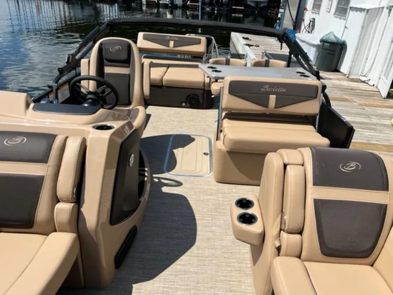 Slide: The Image of 2023 Barletta Cabrio 24 UE pontoon boat with luxurious tan and brown seating. - 37