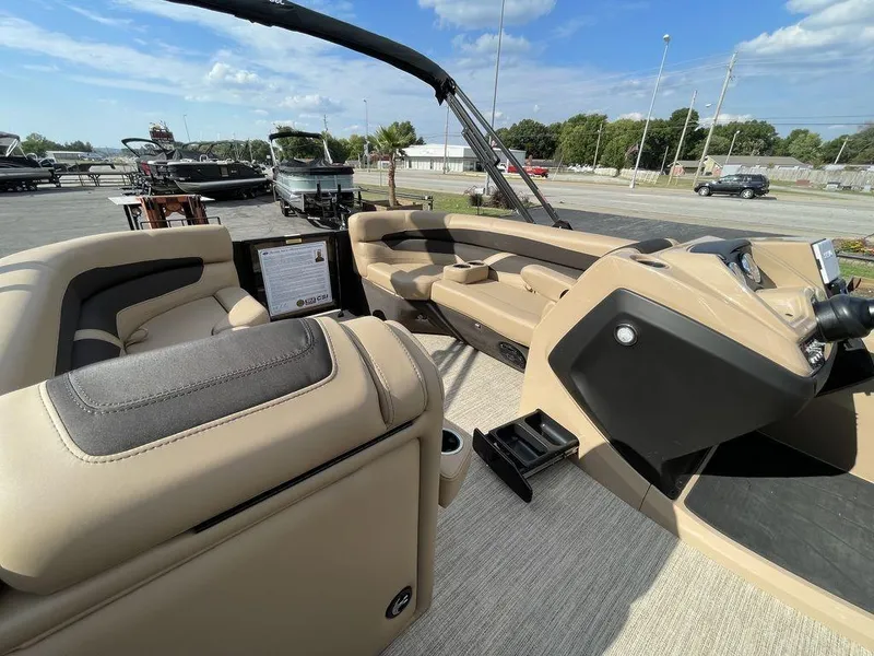 Slide: The Image of 2023 Barletta Cabrio 24 UE pontoon boat interior with beige seating and modern dashboard. - 43