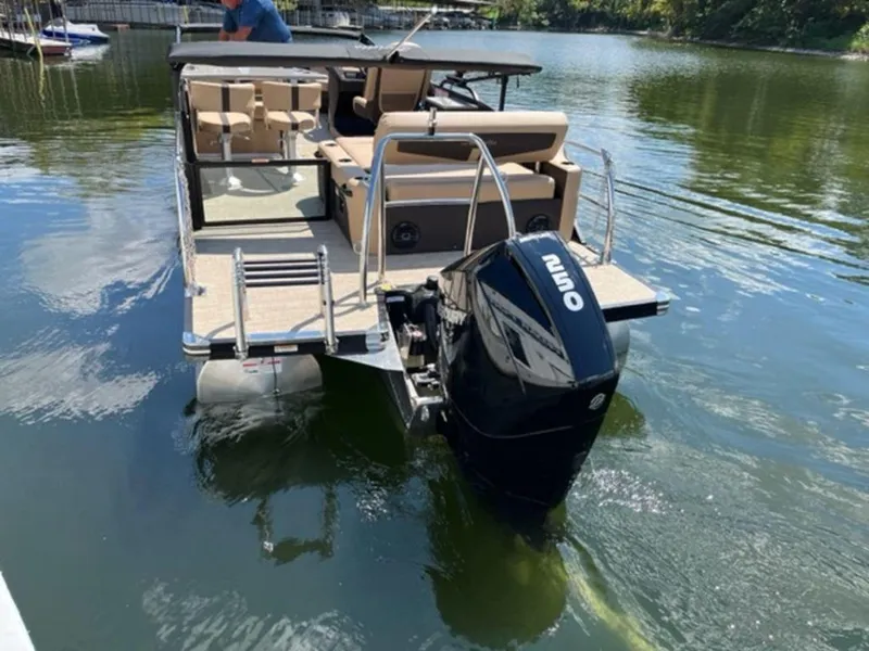 Slide: The Image of 2023 Barletta Cabrio 24 UE pontoon boat with outboard motor on a lake. - 5