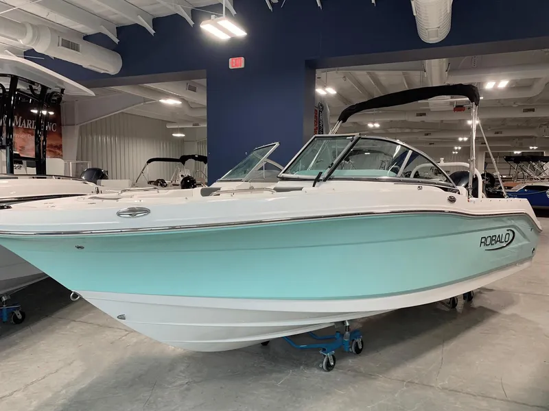Slide: The Image of 2024 Robalo R207 Dual Console boat in showroom. - 0