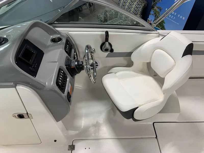 Slide: The Image of 2024 Robalo R207 Dual Console boat interior, captain's seat and helm. - 7