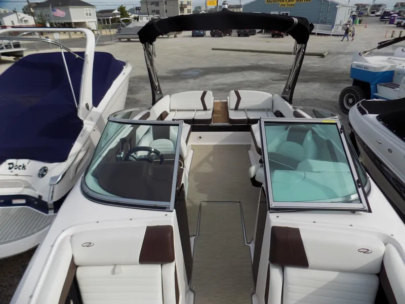 Slide: The Image of 2017 Regal 2500 boat with open deck, seating, and windshield in a marina setting. - 5