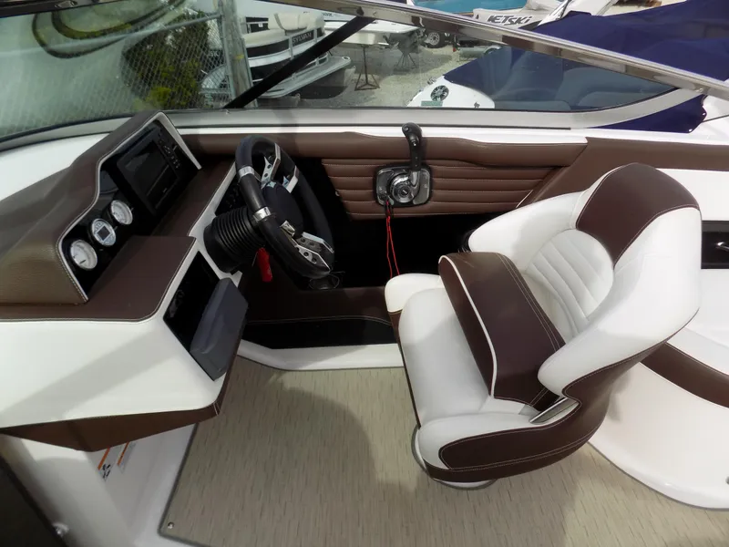 Slide: The Image of Interior of a 2017 Regal 2500 boat, featuring a sleek dashboard and comfortable seating. - 7