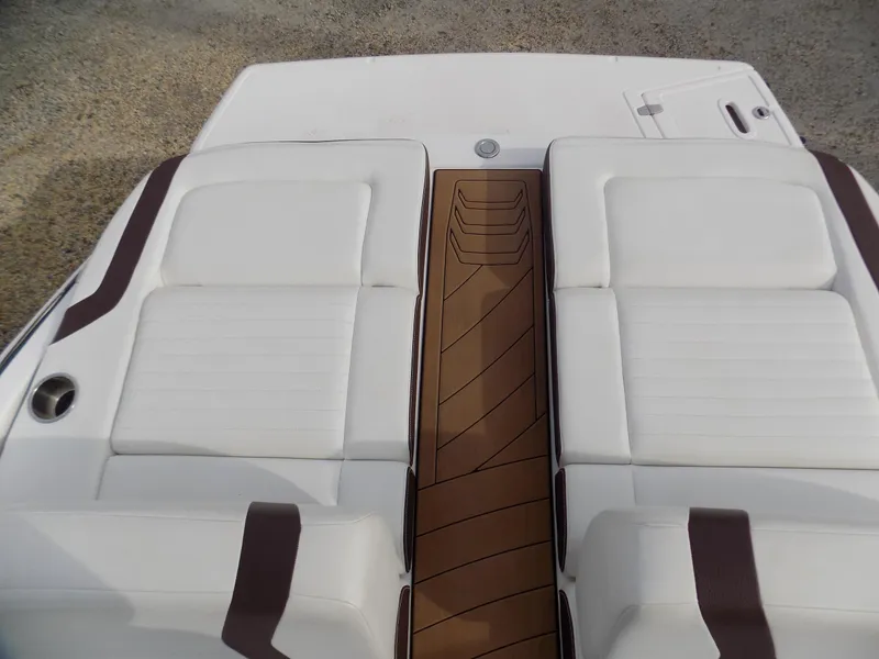 Slide: The Image of 2017 Regal 2500 boat with white cushioned seating and brown accents. - 8