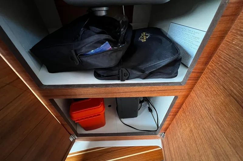 Slide: The Image of Storage compartment in 2021 Ranger Tugs R-29S with bags and equipment. - 14