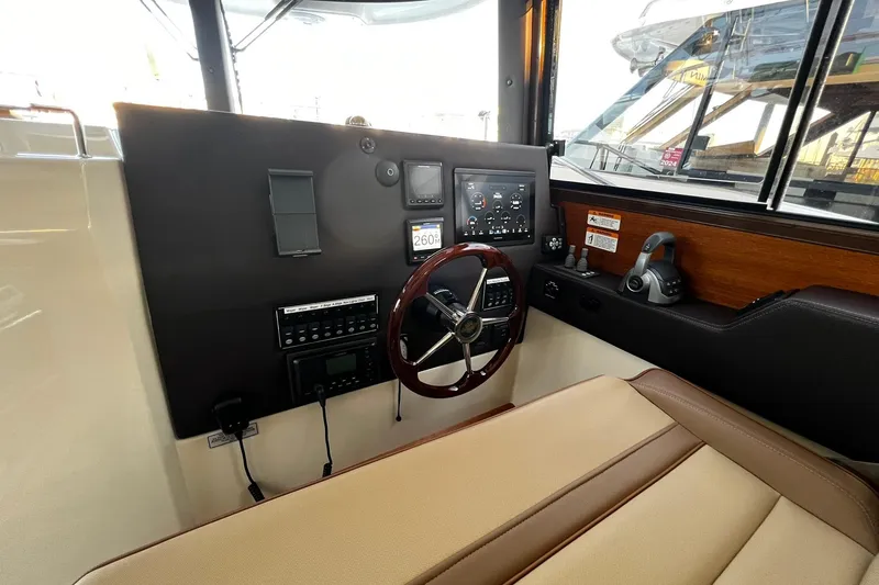 Slide: The Image of 2021 Ranger Tugs R-29S helm with steering wheel and control panel. - 16