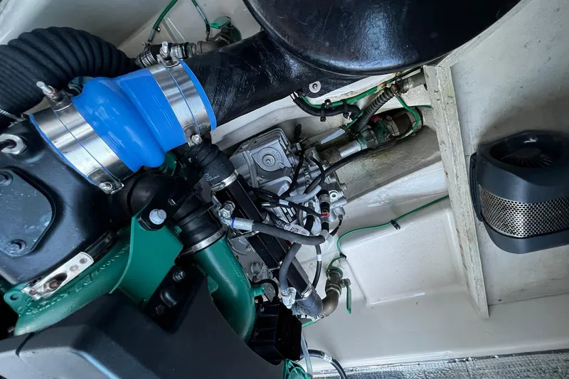 Slide: The Image of Engine compartment of 2021 Ranger Tugs R-29S with visible hoses and components. - 18