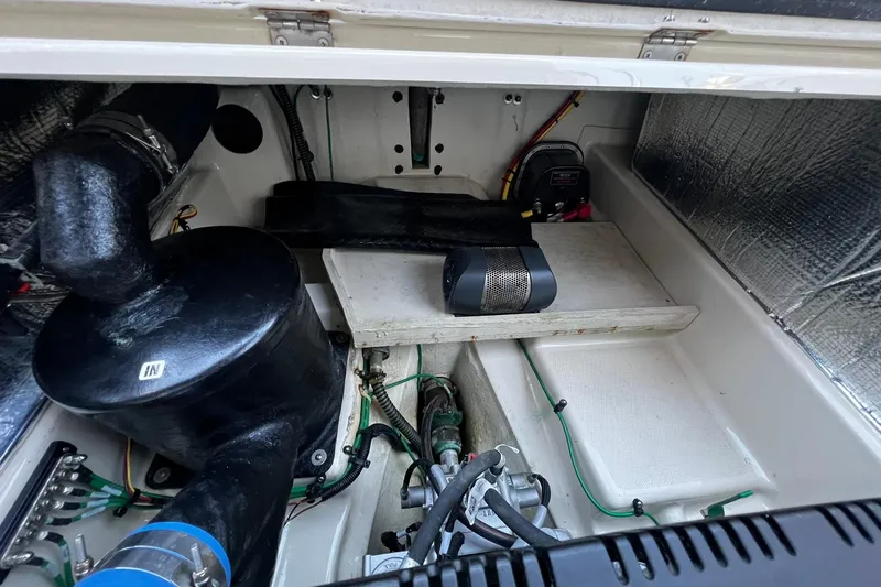 Slide: The Image of Engine compartment of 2021 Ranger Tugs R-29S, showcasing mechanical components and wiring. - 19