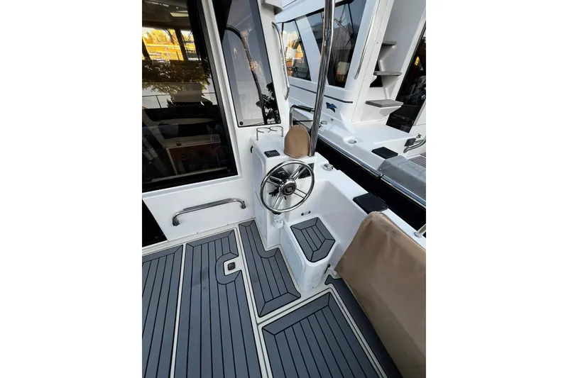 Slide: The Image of 2021 Ranger Tugs R-29S boat helm with sleek design and modern controls. - 2