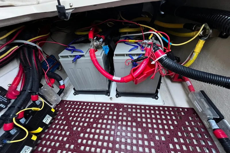 Slide: The Image of 2021 Ranger Tugs R-29S battery compartment with wiring and connections. - 22