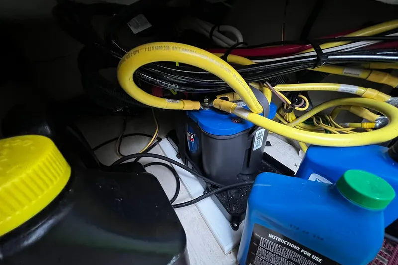 Slide: The Image of Engine compartment of 2021 Ranger Tugs R-29S with hoses and fluid containers. - 25