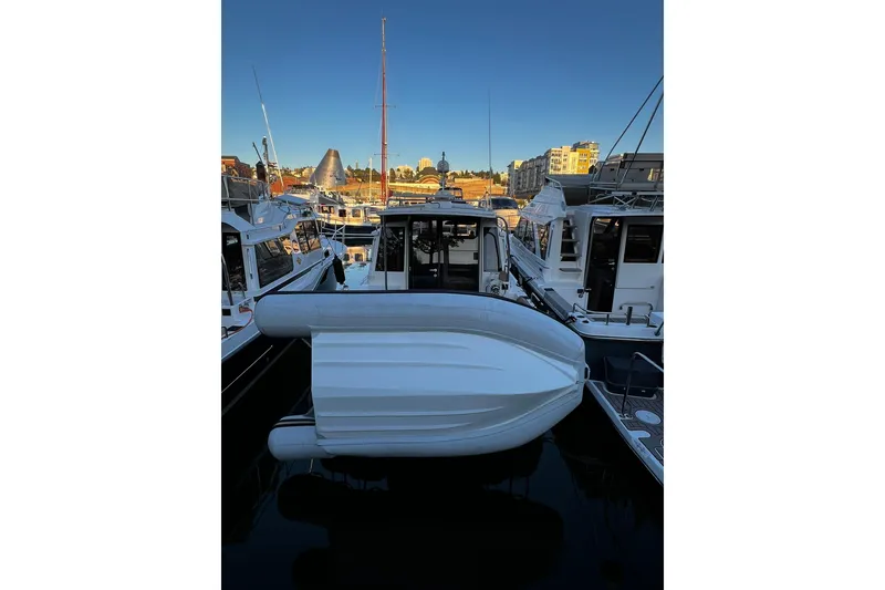 Slide: The Image of 2021 Ranger Tugs R-29S docked at marina, surrounded by other boats. - 3