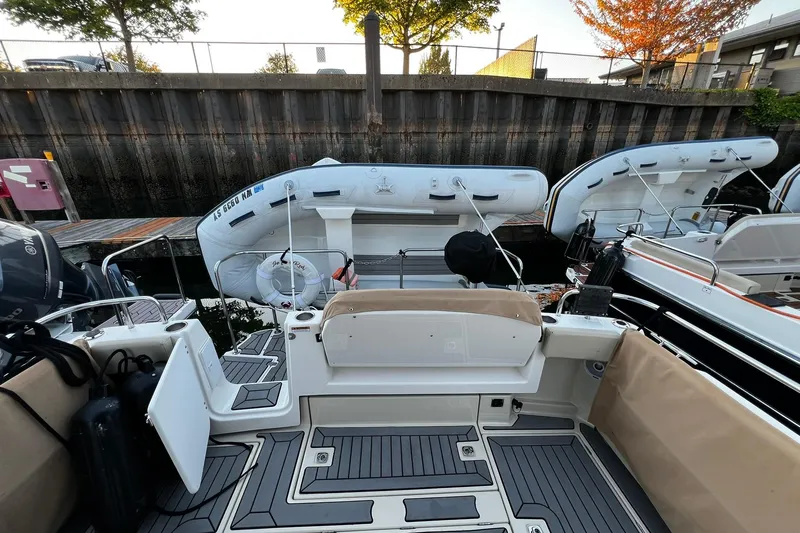 Slide: The Image of 2021 Ranger Tugs R-29S boat with inflatable dinghy docked at marina. - 5