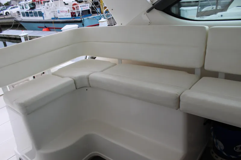 Slide: The Image of 2002 Tiara Yachts 3800 Open interior seating area with white cushions. - 16