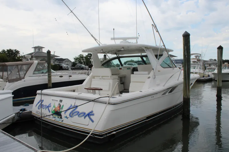 Slide: The Image of 2002 Tiara Yachts 3800 Open docked at a marina. - 3